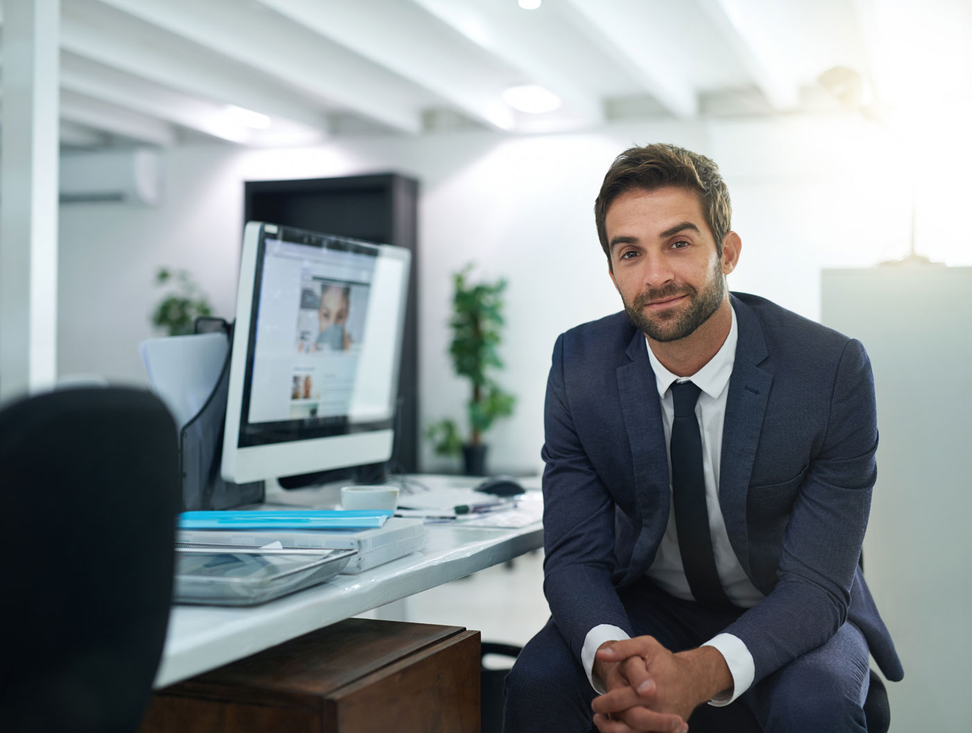A registered agent assisting a business client with vehicle registration paperwork at a modern office.